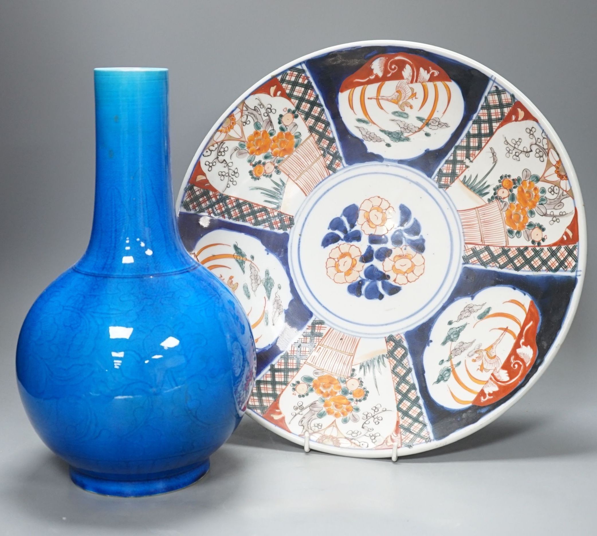A large Japanese turquoise glazed bottle vase and an Imari dish, dish 37 cms diameter.